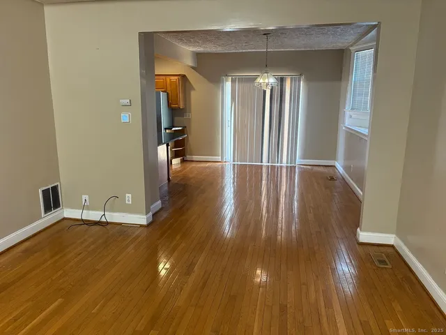 a view of a room with wooden floor