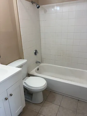 a bathroom with a toilet and a bath tub