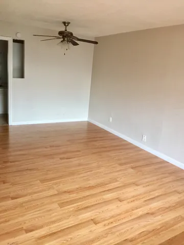 a view of a room with wooden floor