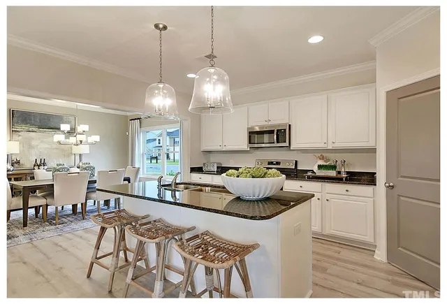 a kitchen with microwave a stove and cabinets