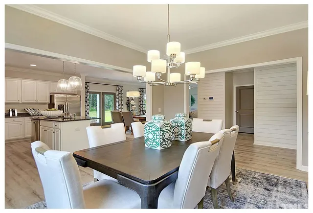 a view of a dining room with furniture and a chandelier