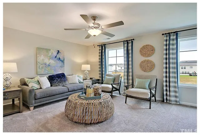 a living room with furniture a table and a window