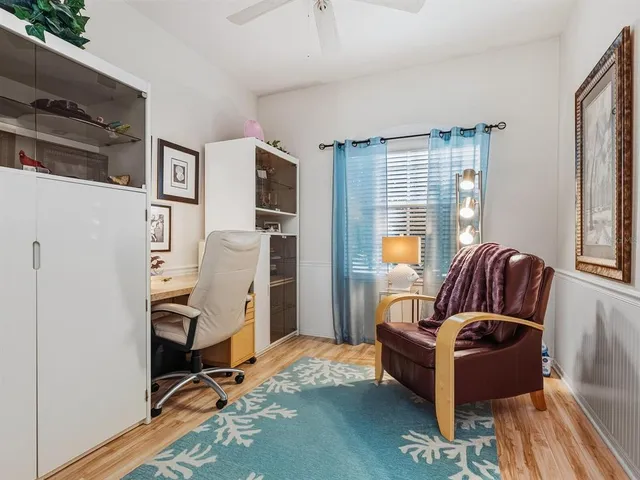 a living room with furniture a window and a flat screen tv