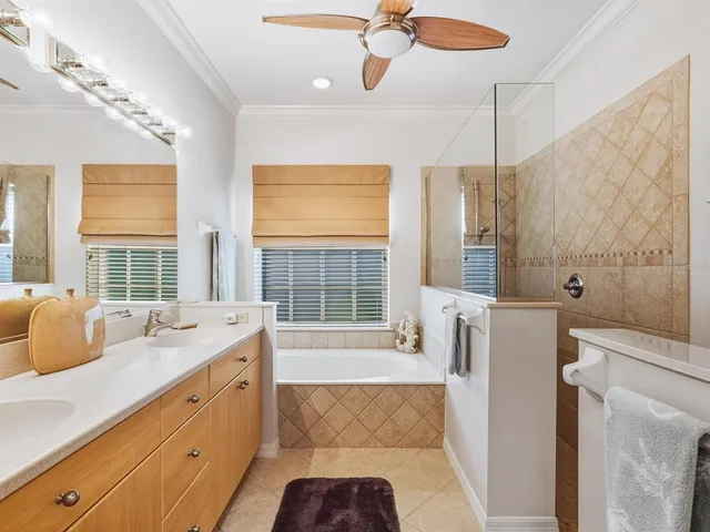 a spacious bathroom with a tub sink and shower