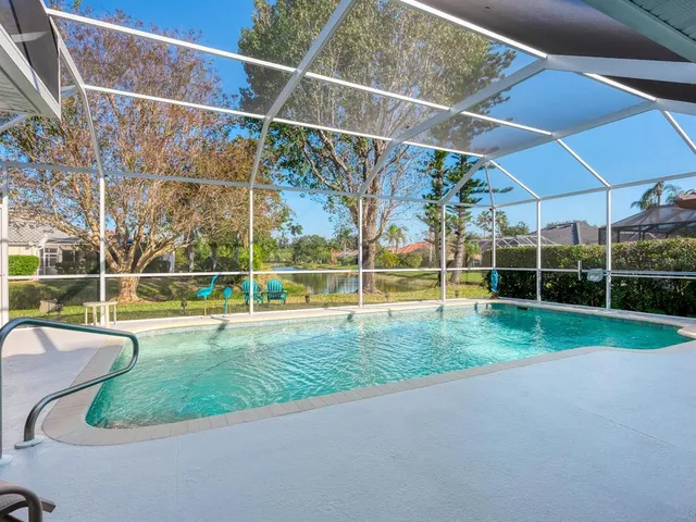 a view of a backyard with swimming pool