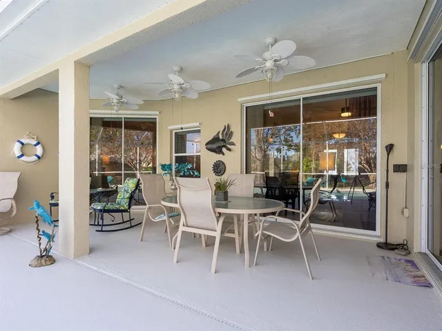 a dining room with furniture floor to ceiling window and floor to ceiling window