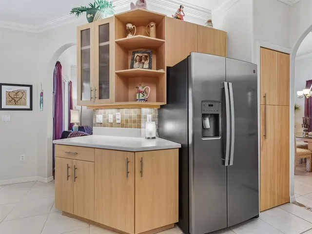 a kitchen with stainless steel appliances granite countertop a refrigerator and a stove