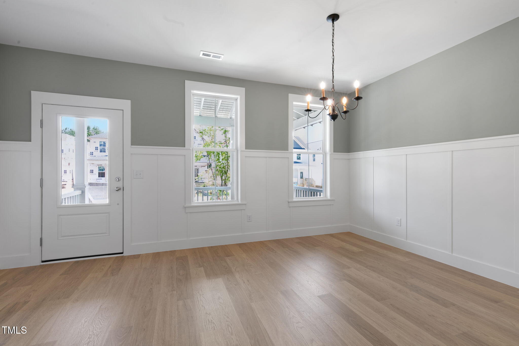 1556 Piney Fls Drive Wendell, NC 27591 - Photo 14 of 43 an empty room with wooden floor chandelier and windows