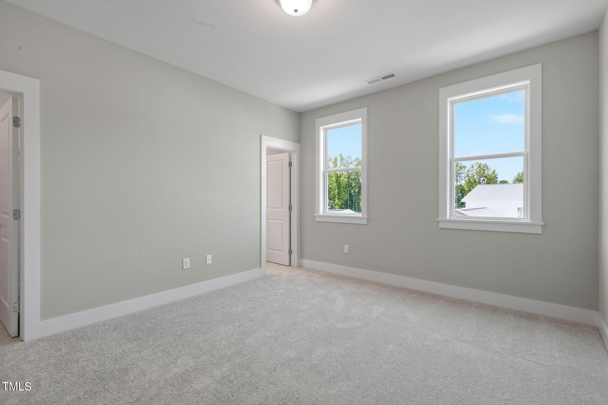 1556 Piney Fls Drive Wendell, NC 27591 - Photo 23 of 43 an empty room with windows and closet
