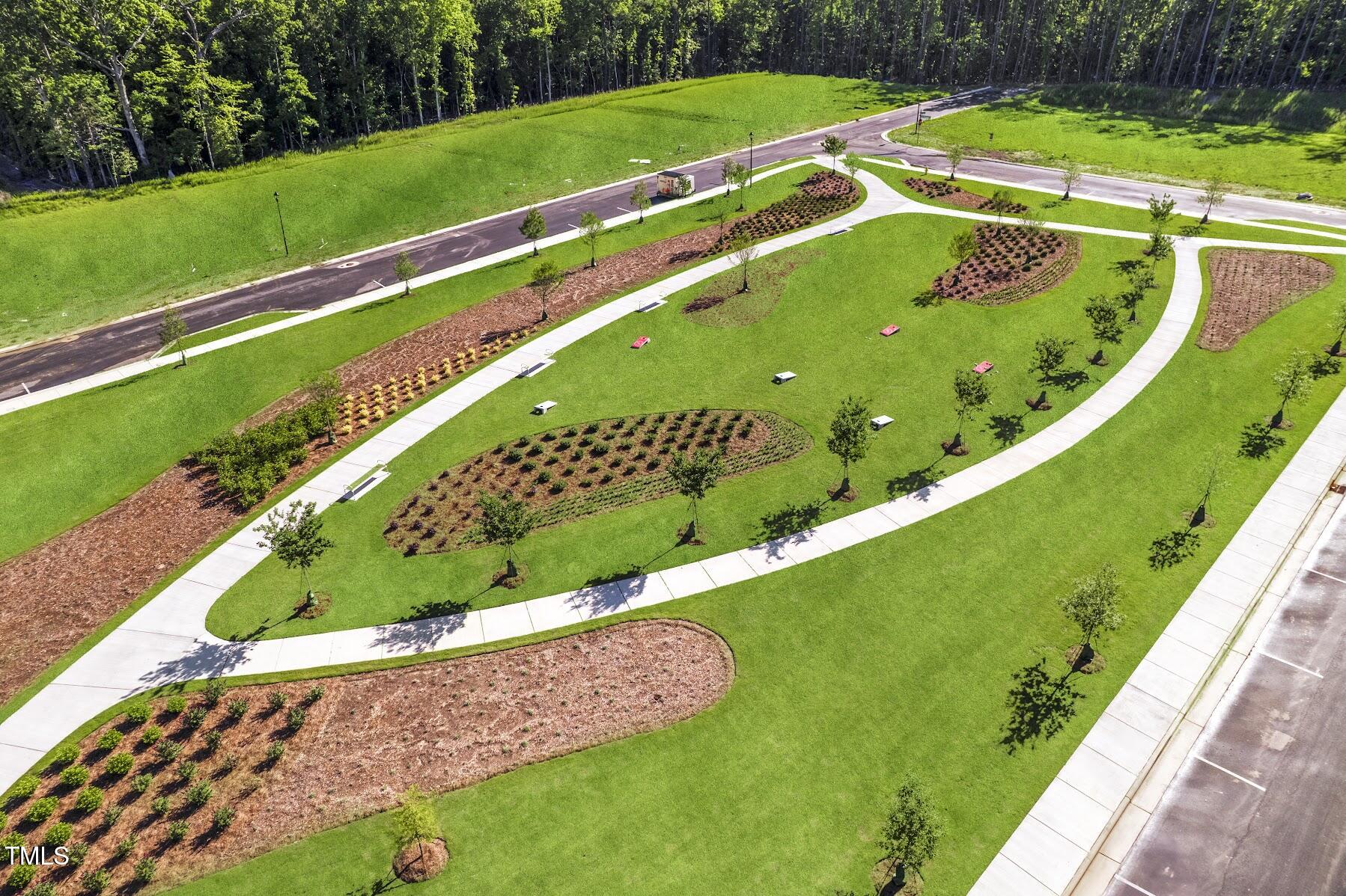 1556 Piney Fls Drive Wendell, NC 27591 - Photo 35 of 43 a view of a swimming pool with a yard and plants