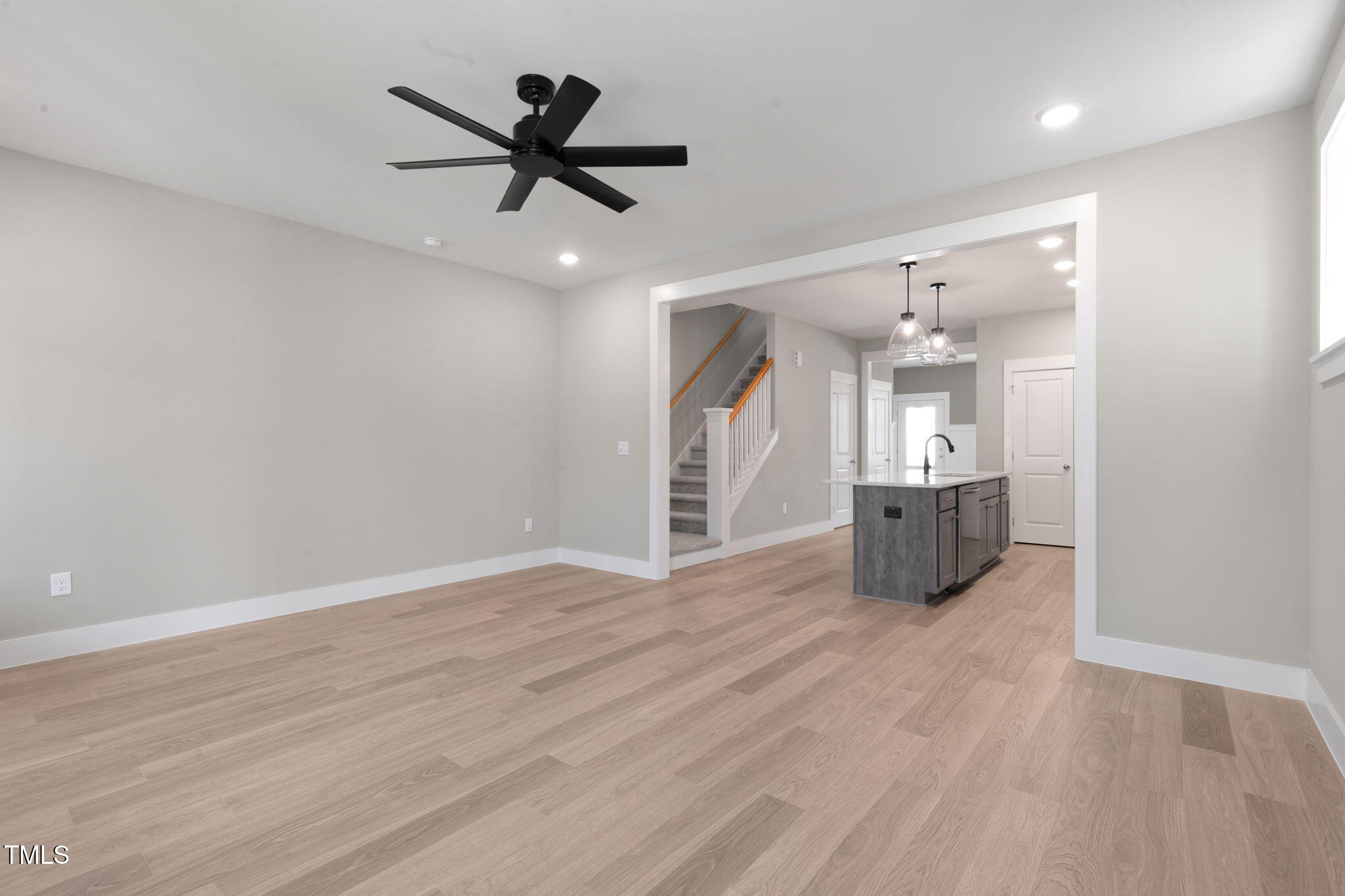 1556 Piney Fls Drive Wendell, NC 27591 - Photo 6 of 43 an empty room with wooden floor and a ceiling fan