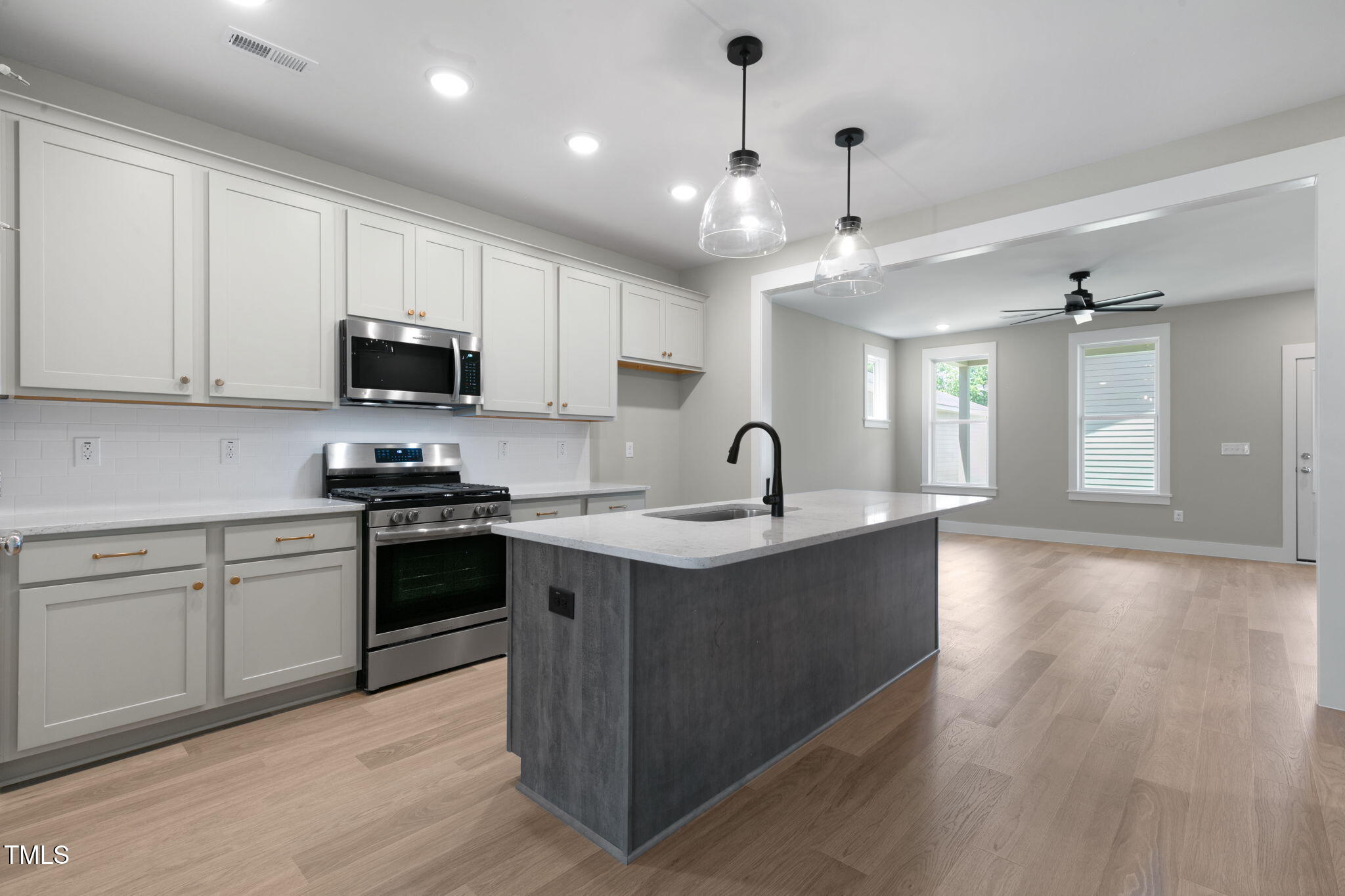 1556 Piney Fls Drive Wendell, NC 27591 - Photo 7 of 43 a kitchen with kitchen island granite countertop a stove top oven a sink a counter space and cabinets