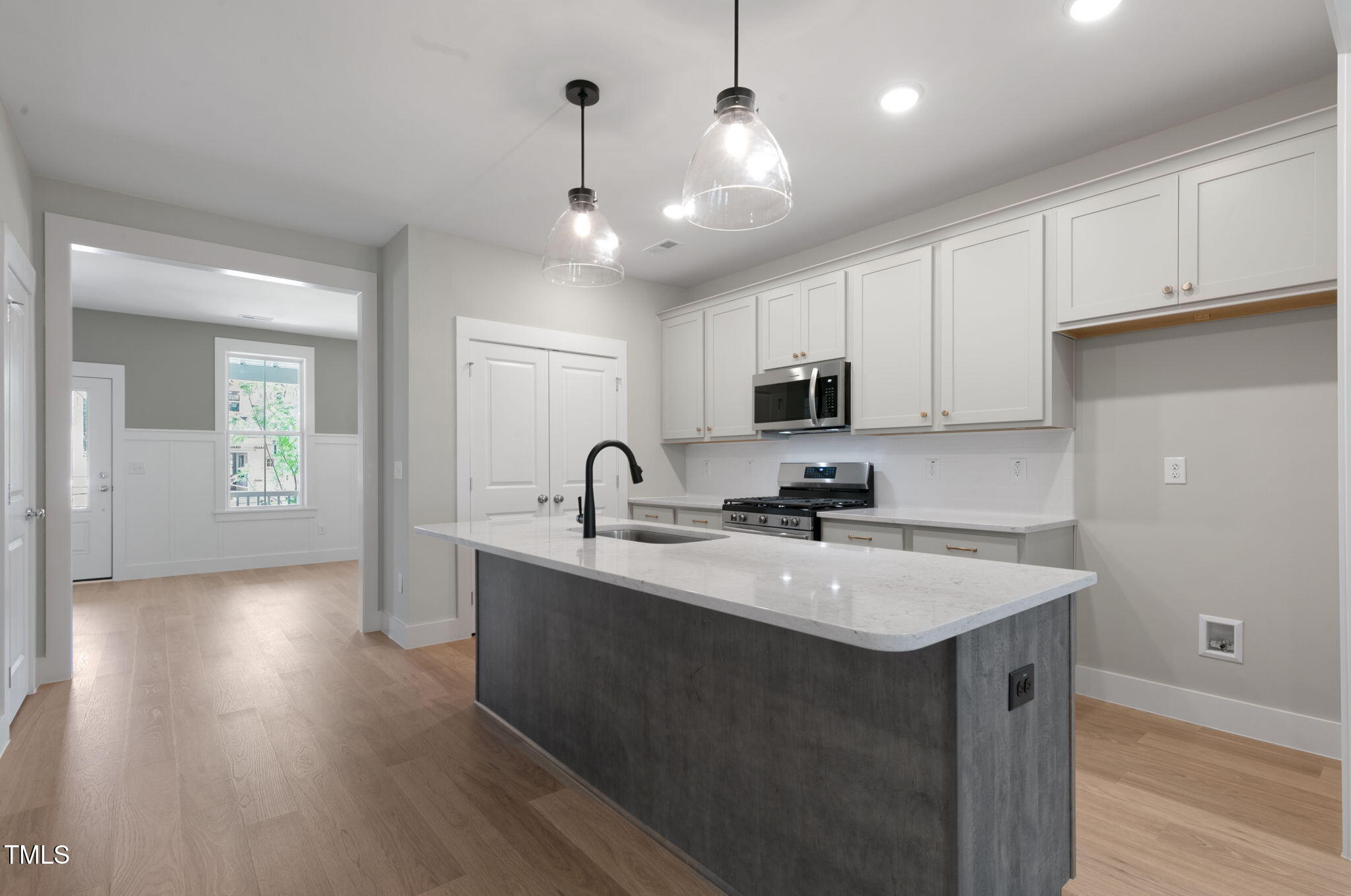 1556 Piney Fls Drive Wendell, NC 27591 - Photo 8 of 43 a kitchen with kitchen island a sink stainless steel appliances and cabinets