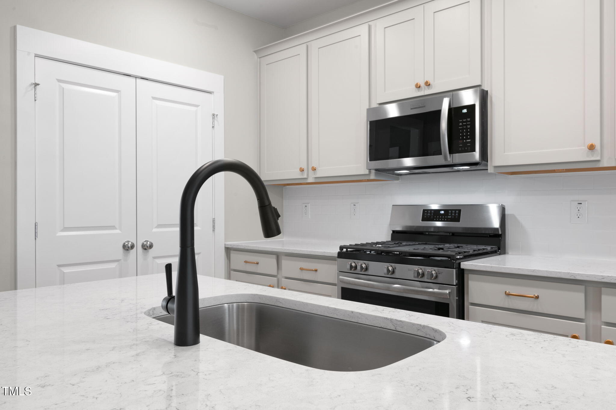 1556 Piney Fls Drive Wendell, NC 27591 - Photo 9 of 43 a kitchen with stainless steel appliances granite countertop a sink a stove a microwave and cabinets