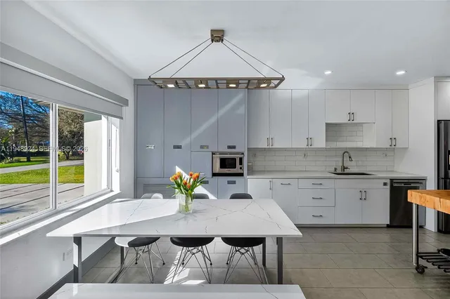 a kitchen with a table chairs and microwave