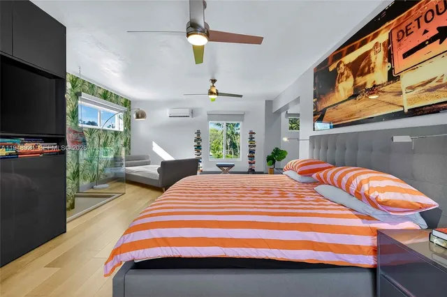 a bedroom with a bed and flat screen tv