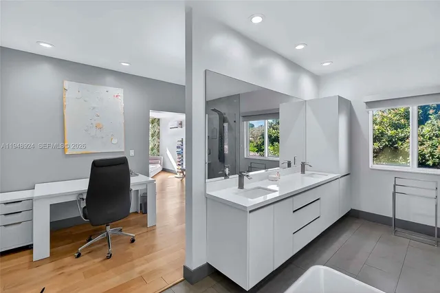a bathroom with a sink vanity and mirror