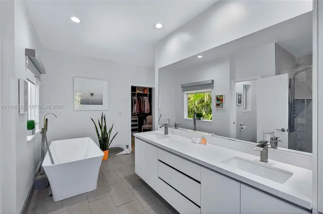 a bathroom with a double vanity sink and a mirror