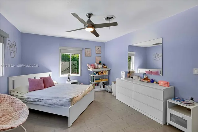 a bedroom with furniture and window