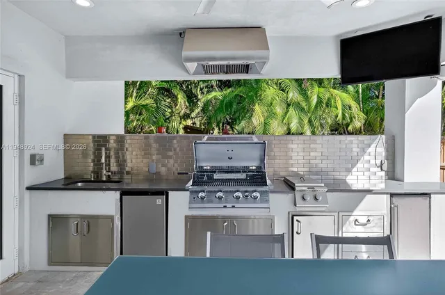 a kitchen with a stove a microwave a sink and a refrigerator