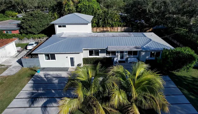 a aerial view of a house roof deck and furniture