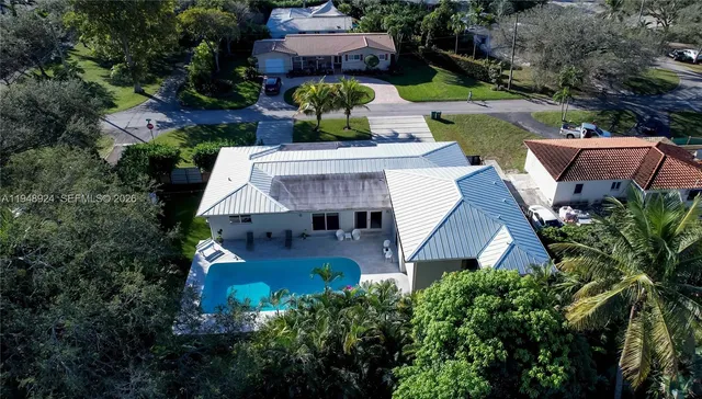 an aerial view of a house with yard swimming pool and outdoor seating
