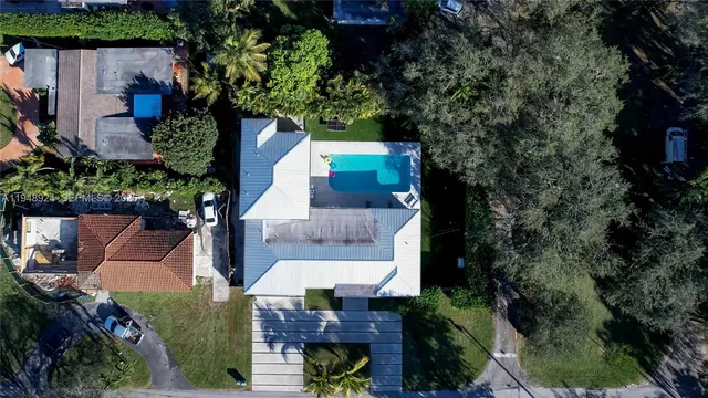 an aerial view of a house with a yard and potted plants