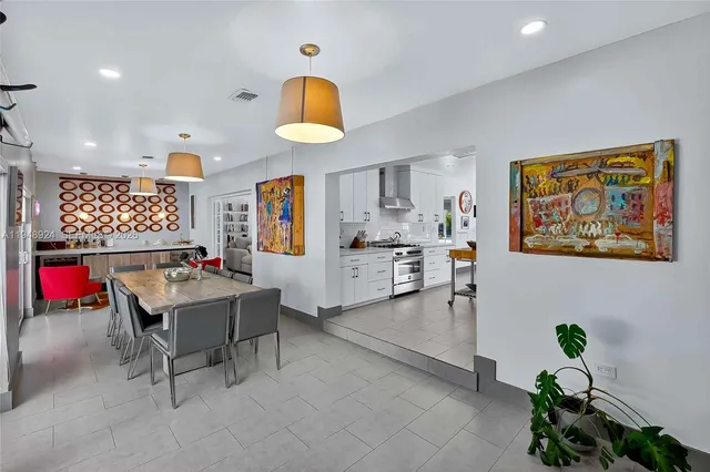 a living room with furniture and a kitchen