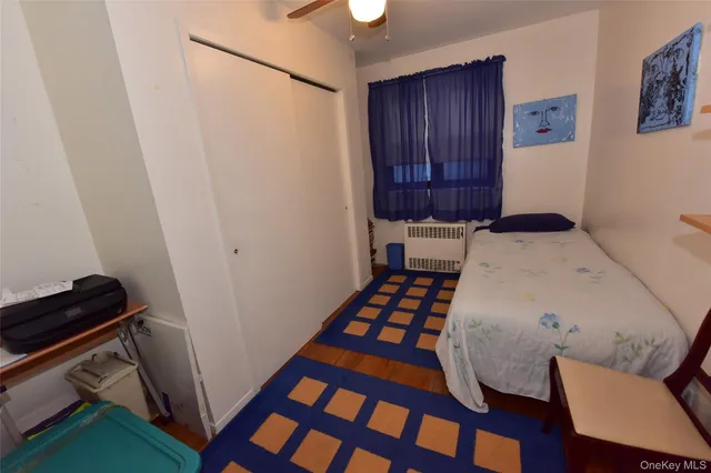 a bedroom with a bed and a dresser in it