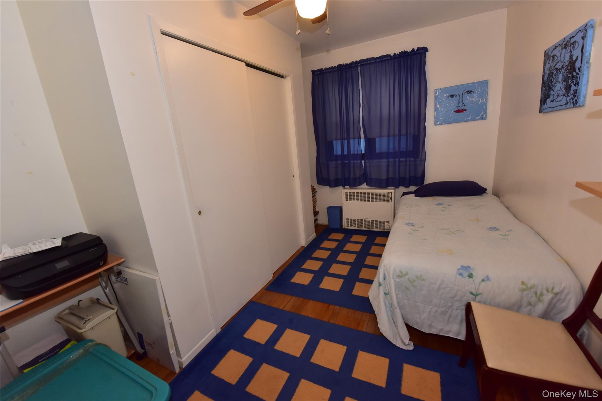 86-70 Francis Lewis Boulevard, Unit A46 Queens, NY 11423 - Photo 12 of 12 a bedroom with a bed and a dresser in it