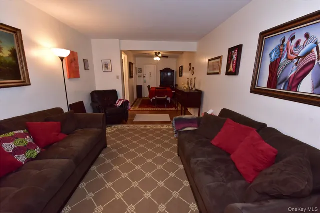 a living room with furniture and painting on the wall