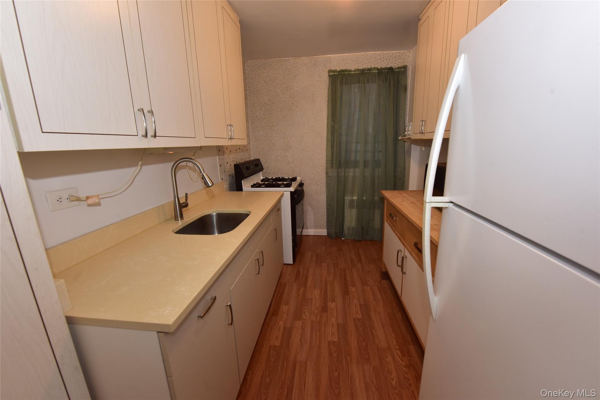 86-70 Francis Lewis Boulevard, Unit A46 Queens, NY 11423 - Photo 6 of 12 a storage room with wooden floor washer and dryer