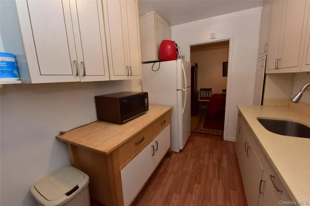 a kitchen with a refrigerator and a sink