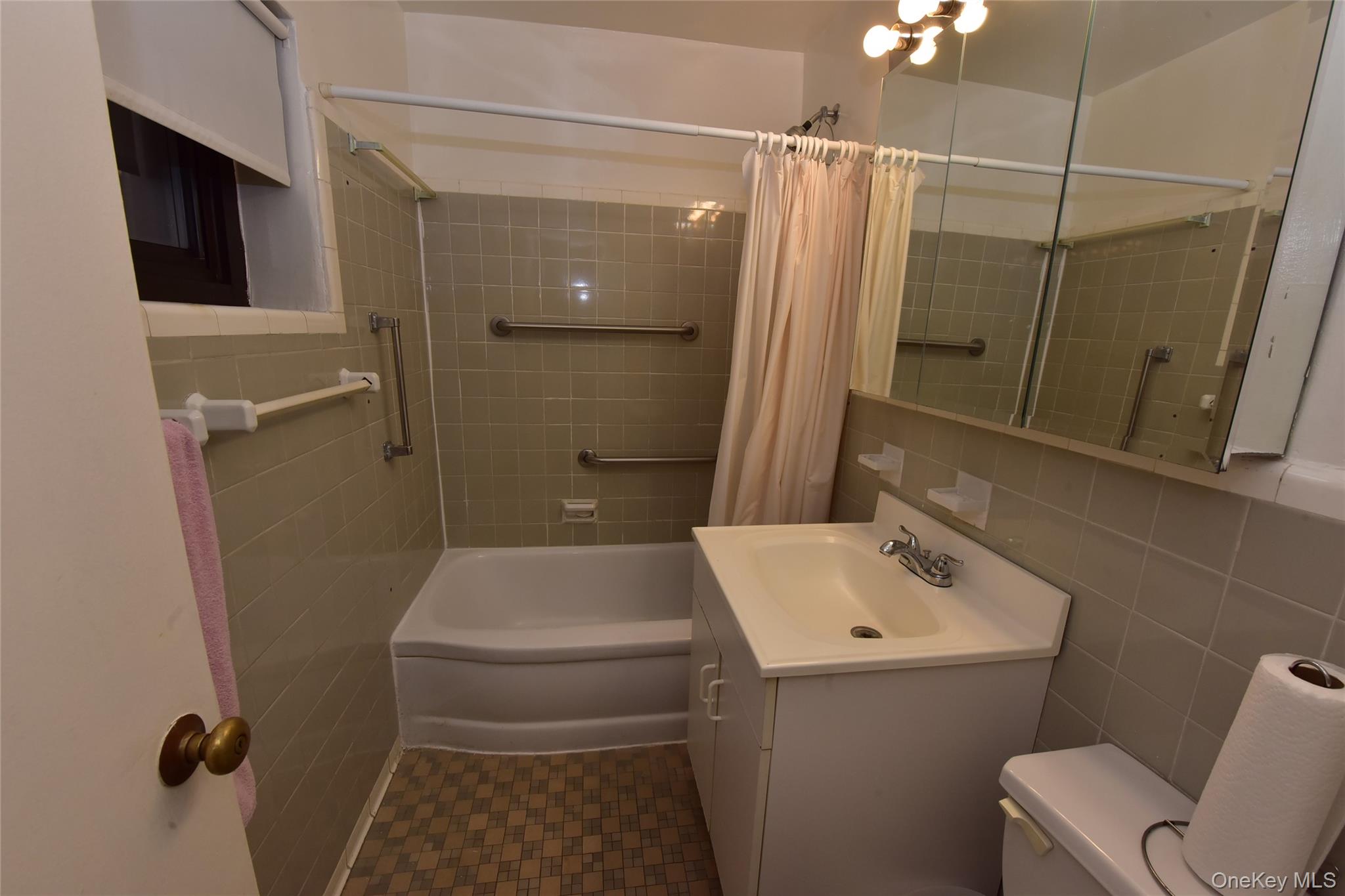 86-70 Francis Lewis Boulevard, Unit A46 Queens, NY 11423 - Photo 8 of 12 a bathroom with a sink a toilet and shower