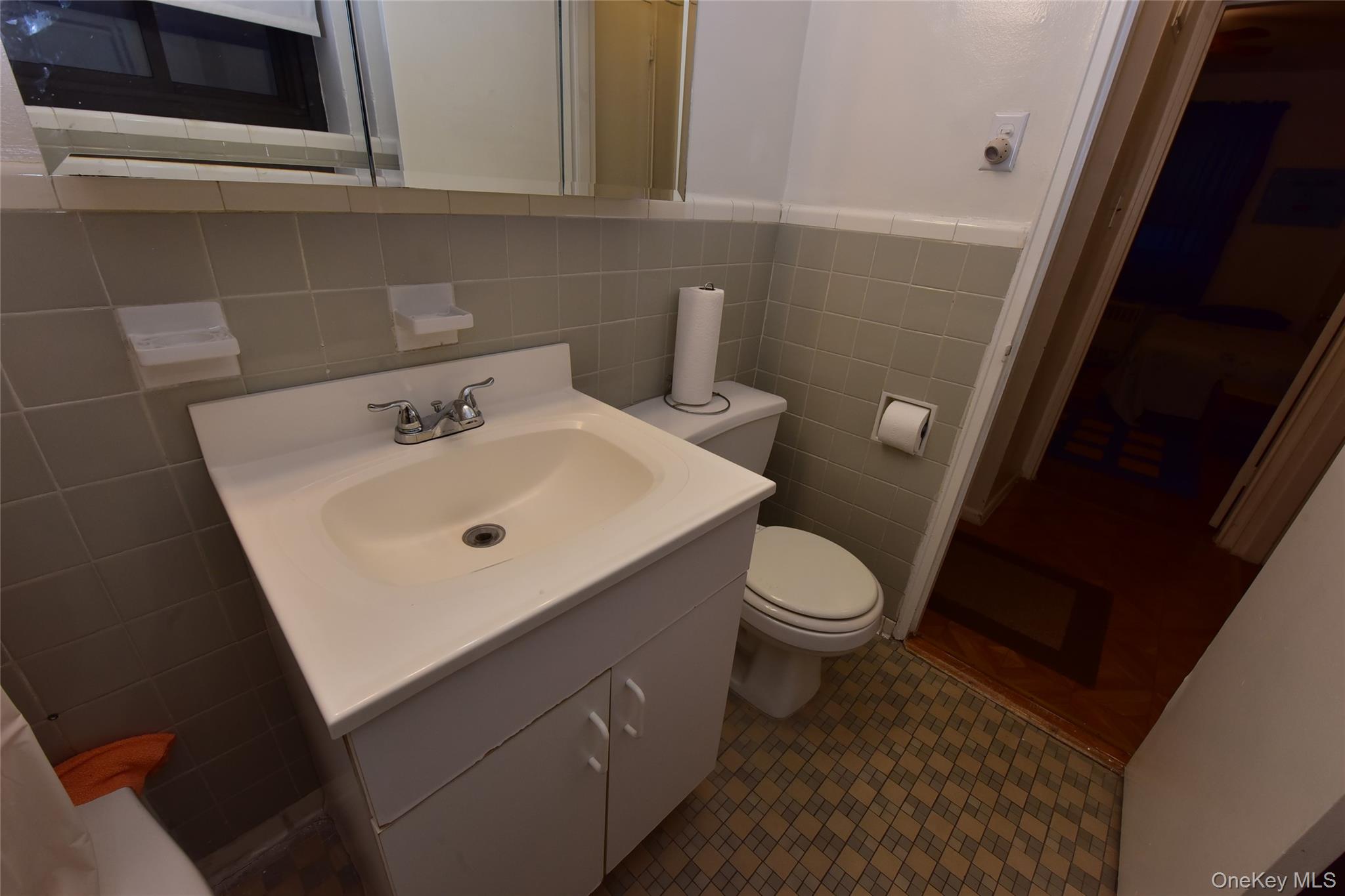 86-70 Francis Lewis Boulevard, Unit A46 Queens, NY 11423 - Photo 9 of 12 a bathroom with a sink toilet and mirror