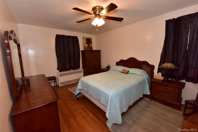 a bed room with a bed window and a television