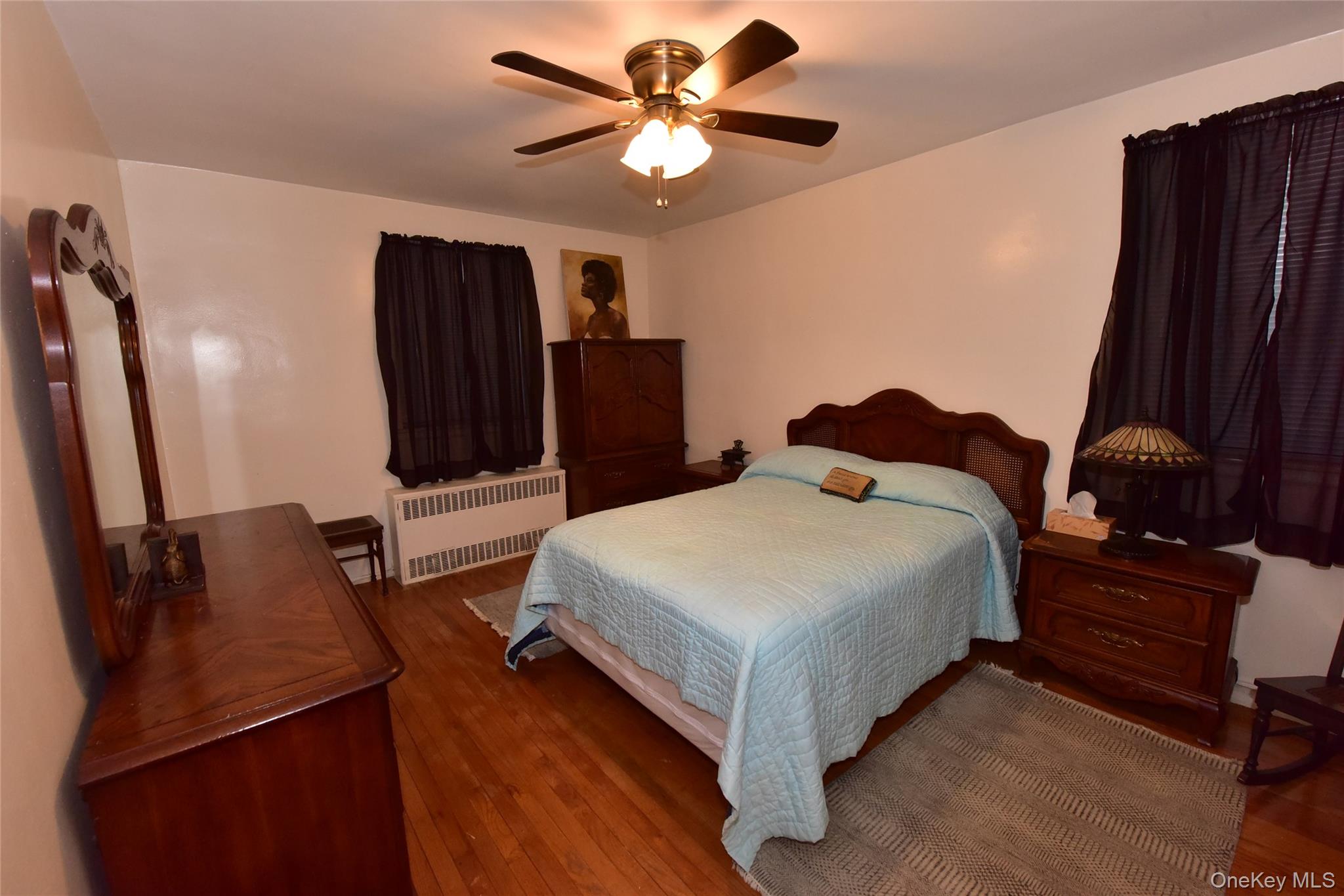 86-70 Francis Lewis Boulevard, Unit A46 Queens, NY 11423 - Photo 10 of 12 a bed room with a bed window and a television