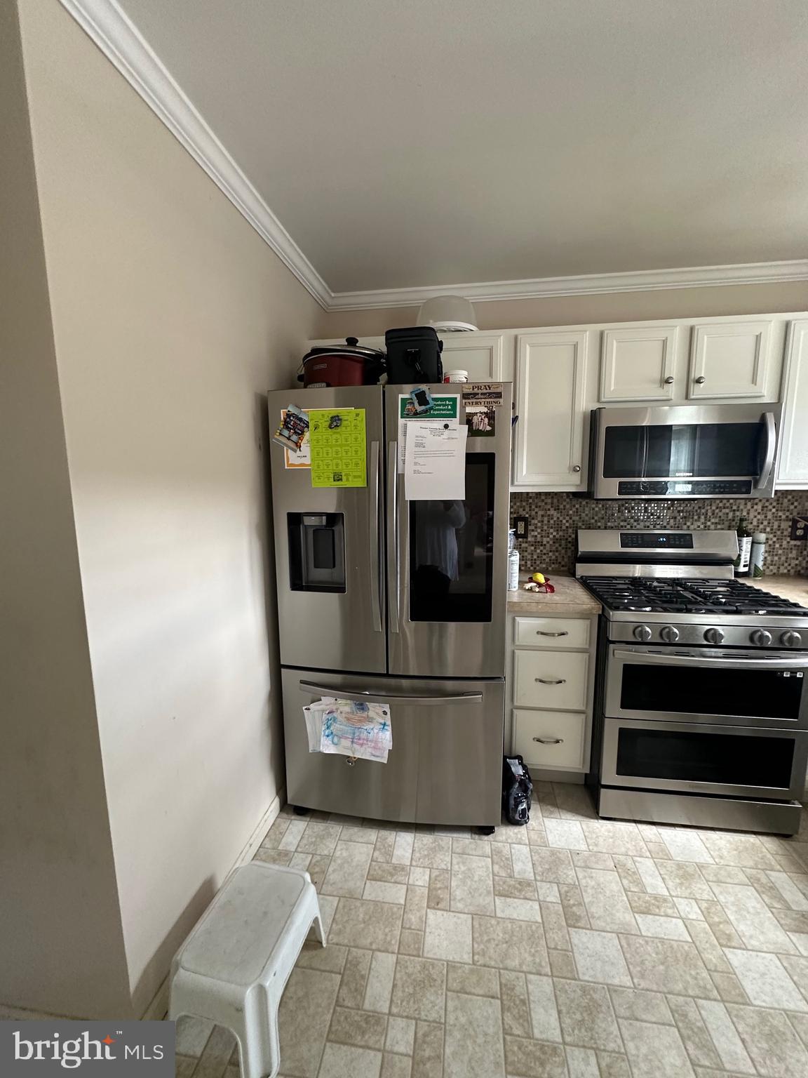 109 Harmony Cir Road Sicklerville, NJ 08081 - Photo 56 of 118 a kitchen with stainless steel appliances a stove a microwave and a refrigerator