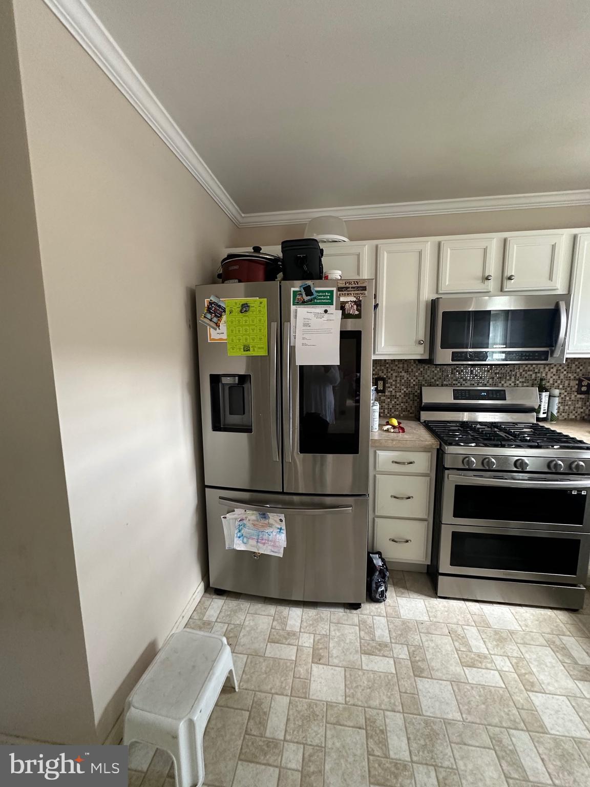 109 Harmony Cir Road Sicklerville, NJ 08081 - Photo 68 of 118 a kitchen with stainless steel appliances a stove a microwave and a refrigerator
