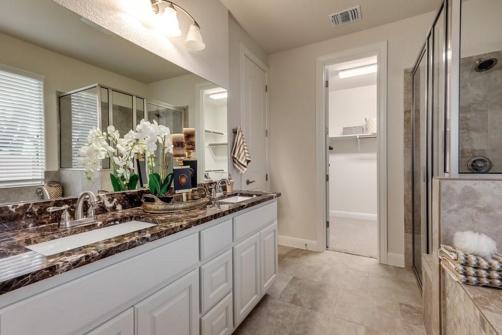 10825 Ballard Path Austin, TX 78717 - Photo 22 of 39 a bathroom with a double vanity sink and a mirror