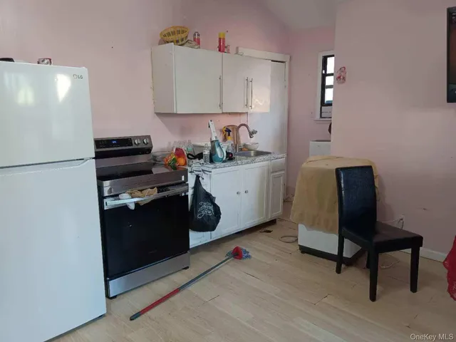 a kitchen with a refrigerator and a stove top oven