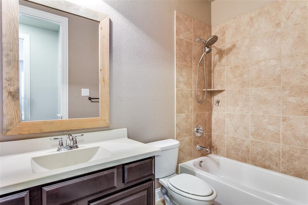 1505 5th Street Argyle, TX 76226 - Photo 6 of 25 a bathroom with a sink a toilet and shower
