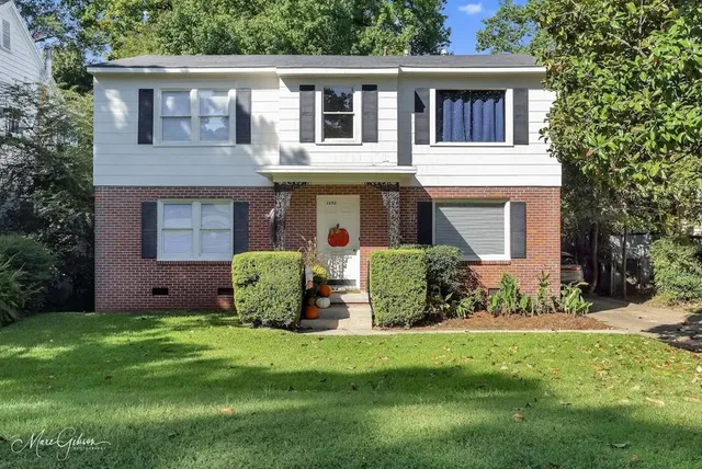 a front view of a house with garden
