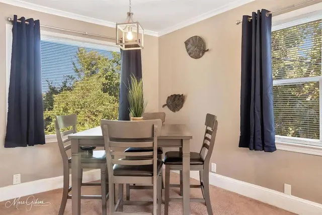 a dining room with furniture and window
