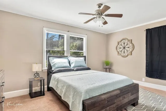 a bedroom with a large bed and a chandelier
