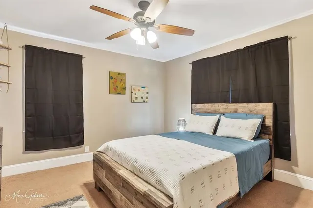 a bedroom with a large bed and a chandelier