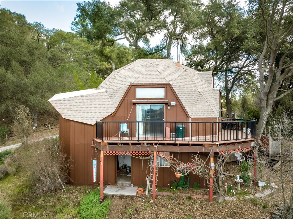 a view of a house with a yard balcony and furniture