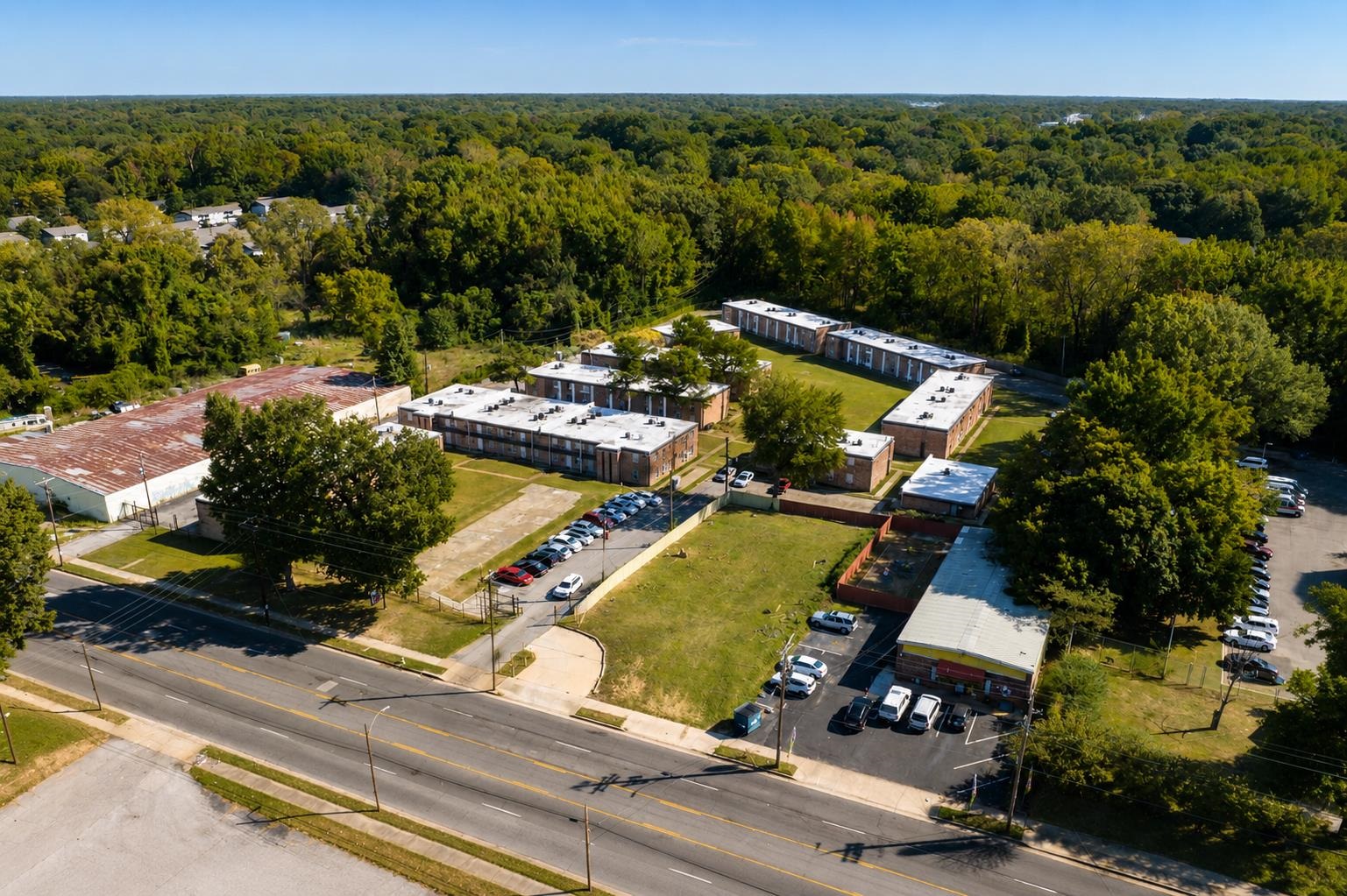 3236 Millington Road Memphis, TN 38127 - Photo 2 of 31 Aerial perspective showcasing multiple brick apartment buildings with white roofs