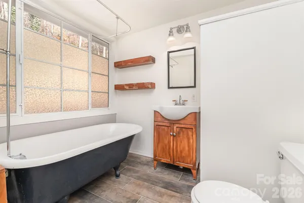 a bathroom with a sink a toilet and bathtub