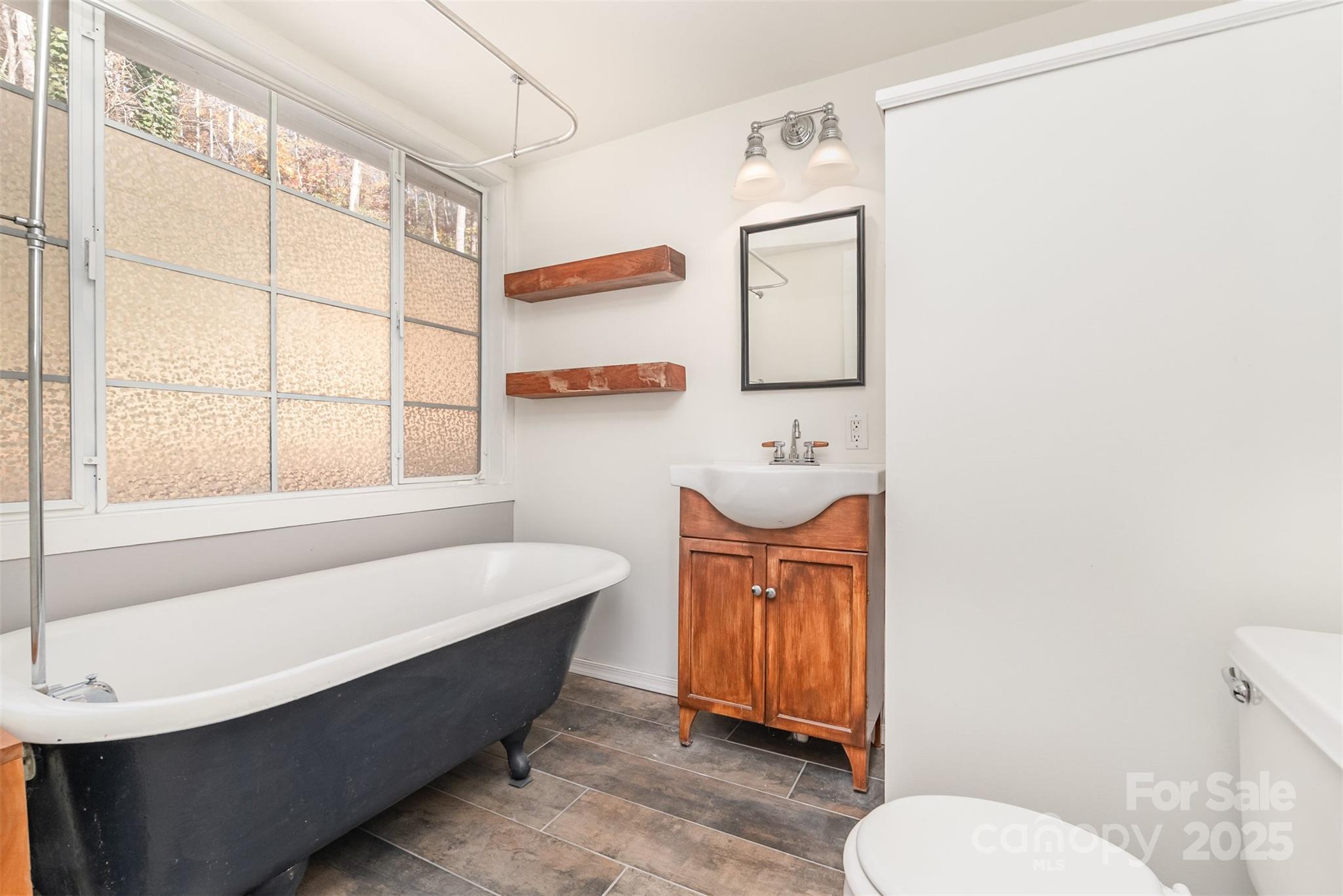 243 Boys Camp Road Black Mountain, NC 28711 - Photo 12 of 21 a bathroom with a sink a toilet and bathtub